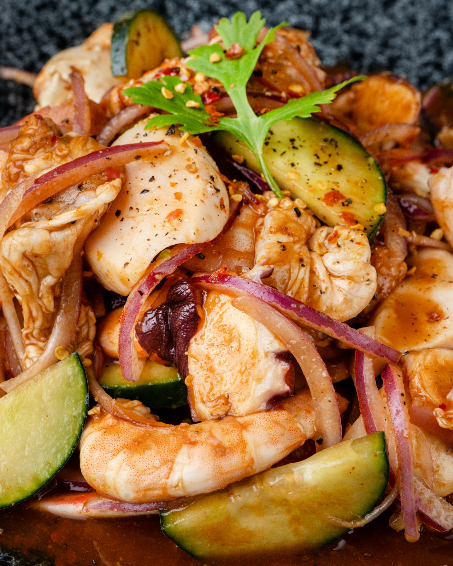 Molcajete de mariscos with shrimp, octopus, cucumber and red onion
